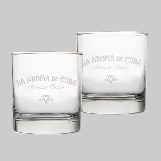 Two clear glass tumblers with 'La Aroma de Cuba' engraving on a white background